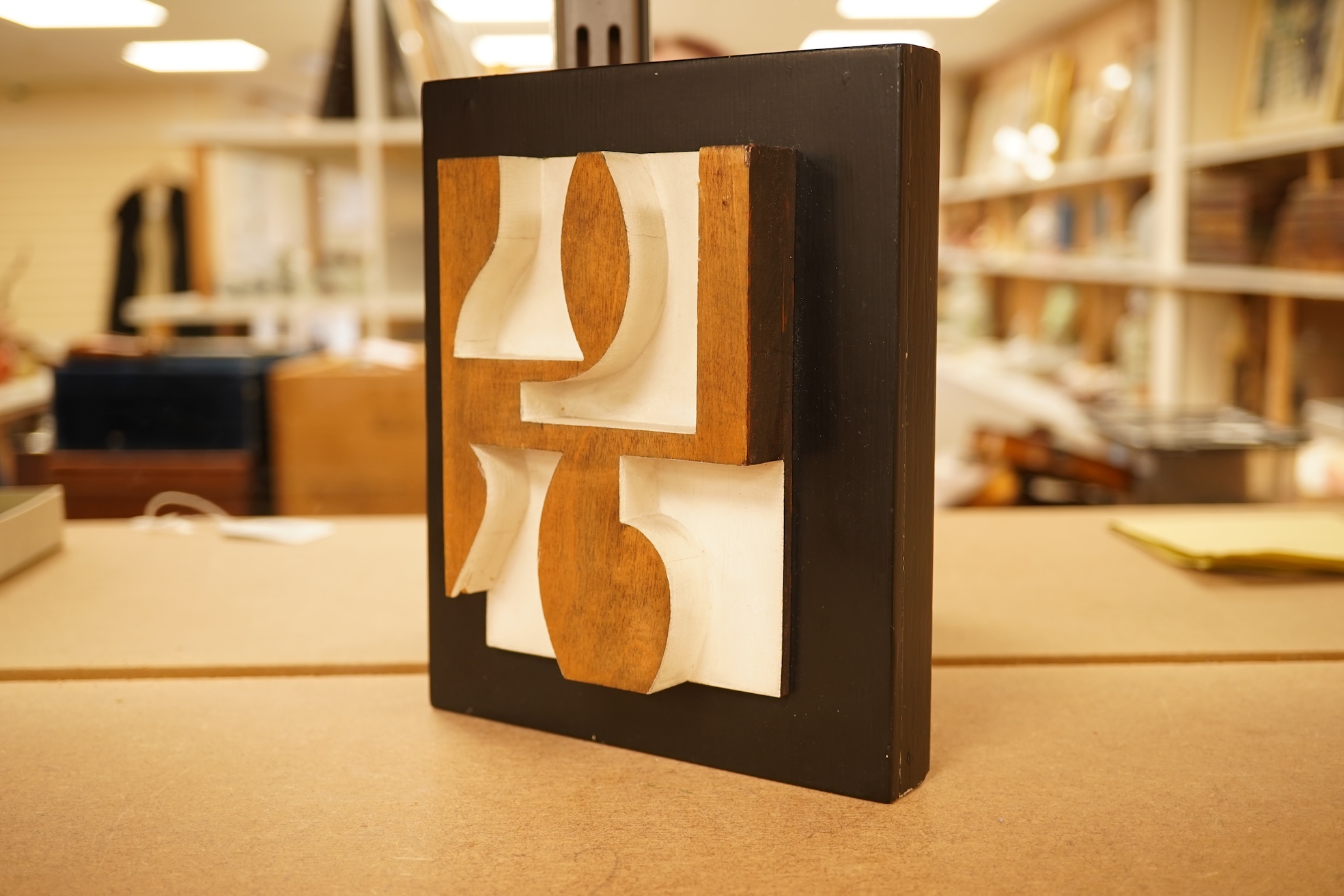 Donald Wells, a carved oak relief sculpture with gallery leaflet, 19cm high